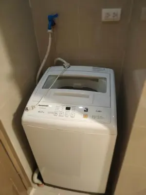 a washing machine in a corner of a room at Bb Drew Rooms Near Airports in Manila