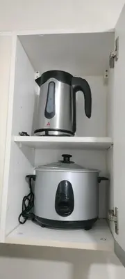 a tea kettle sitting on top of a pot in a shelf at Bb Drew Rooms Near Airports in Manila