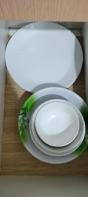 a white plate sitting on a table with a plate at Rqui Rooms Near Airport in Manila