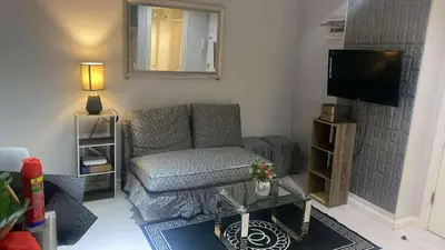 a living room with a couch and a tv at St Tropez PH 07 in Manila