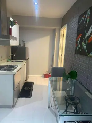 a small kitchen with a glass table in a room at St Tropez PH 07 in Manila