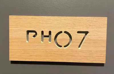 a wooden sign with the word flip on a wall at St Tropez PH 07 in Manila