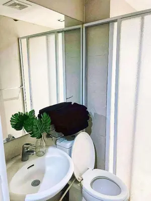 a bathroom with a white toilet and a sink at St Tropez PH 07 in Manila