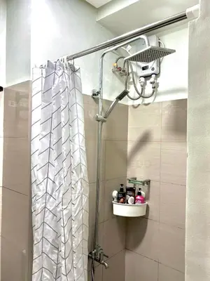 a shower in a bathroom with a shower curtain at Stylish 1BR Condo at Shore Netflix & Chill-Pool View in Manila