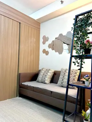 a living room with a couch and a ladder at Stylish 1BR Condo at Shore Netflix & Chill-Pool View in Manila