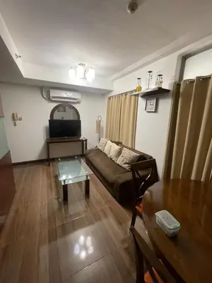 a living room with a couch and a table at A venue Residences 1801 in Manila