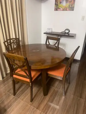 a wooden table with chairs and a table with a laptop on it at A venue Residences 1801 in Manila