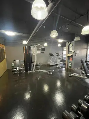 a gym with dumbbells and machines in a room at A venue Residences 1801 in Manila