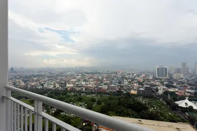 a view of a city from a balcony at Fully Furnished 1BR Condo at Jazz Residences in Manila
