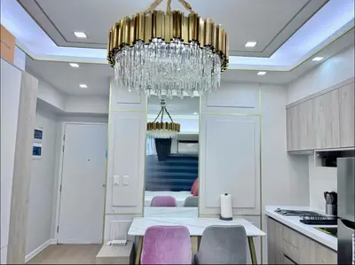 a chandelier in a kitchen with a table and chairs at Chic BGC Stay - Hotel Vibes in Manila