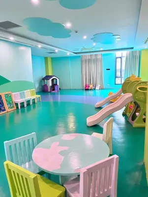a play room with a table and a slide at Chic BGC Stay - Hotel Vibes in Manila