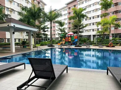 a swimming pool with chairs and a playground in a building at Elim Escape Staycation in Trece Martires