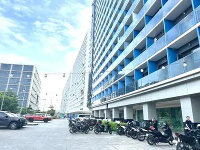 a row of motorcycles parked outside of a building at Elegant yet Affordable condo in Pasay in Manila