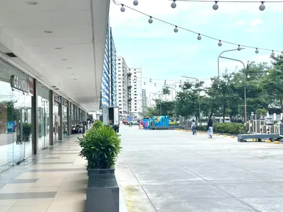 a building with a plant in the middle of a street at Elegant yet Affordable condo in Pasay in Manila