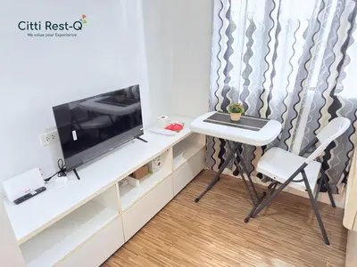 a room with a table and a tv and a chair at Studio City Alabang Pool Access Free for 2 Wifi & Netflix SC4 in Manila