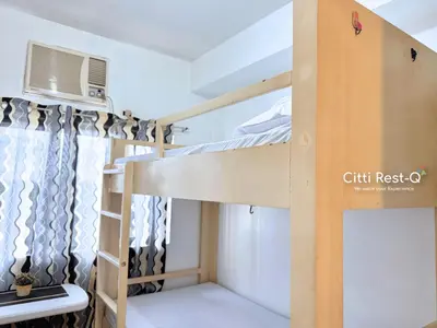 a bedroom with two bunk beds and a window at Studio City Alabang Pool Access Free for 2 Wifi & Netflix SC4 in Manila
