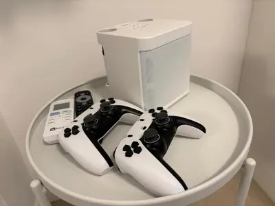 two video game controllers and a computer on a table at Azure Boracay Tower 1BR in Manila