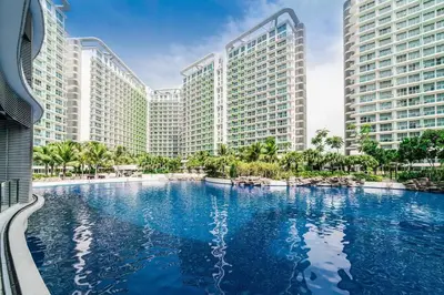 a large swimming pool in front of tall buildings at Azure Boracay Tower 1BR in Manila