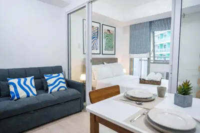 a living room with a couch and a table at Azure Boracay Tower 1BR in Manila