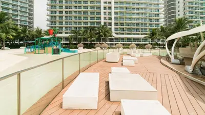 a balcony with white benches and a playground at Azure Boracay Tower 1BR in Manila