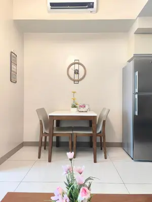 a dining room with a table and a refrigerator at 1BR Amazing View Condo in Uptown BGC by Terravista in Manila