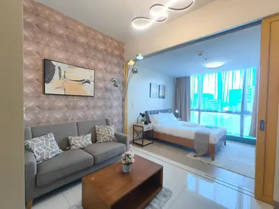 a living room with a bed and a couch at 1BR Amazing View Condo in Uptown BGC by Terravista in Manila