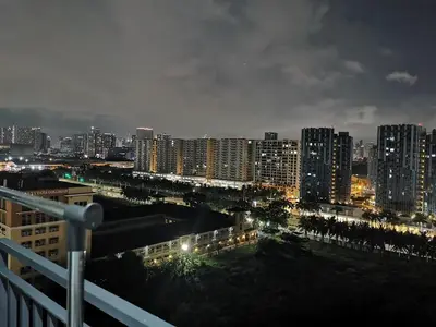 a view of a city at night with buildings at Mall of Asia Shore condo in Manila