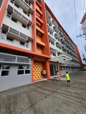 two children standing in front of a building at Cozy place near pavilion mall and Sm starosa in Biñan