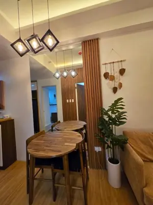 a living room with a table and a couch at Cozy place near pavilion mall and Sm starosa in Biñan