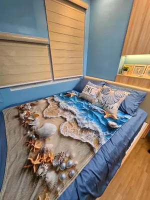 a bedroom with a bed with a painting on it at Cozy place near pavilion mall and Sm starosa in Biñan