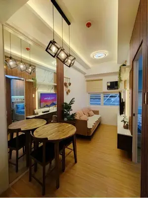 a living room with two tables and a couch at Cozy place near pavilion mall and Sm starosa in Biñan