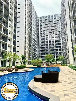 a swimming pool with tall buildings in the background at EMZ SHORE2 Staycation 16 in Manila