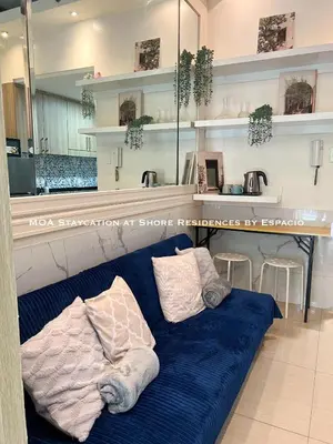 a blue couch with two pillows on it in a store at Ezpacio in Manila