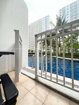 a balcony with a view of a swimming pool at Ezpacio in Manila