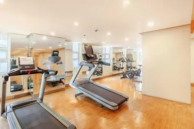 a gym with several exercise bikes and a treadmill at Roam & Rest Staycation near NAIA Manila Airport and free WiFi in Manila
