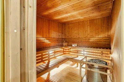an empty sauna with wooden walls and a wooden ceiling at Roam & Rest Staycation near NAIA Manila Airport and free WiFi in Manila