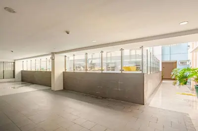 a lobby of a building with windows and plants at Roam & Rest Staycation near NAIA Manila Airport and free WiFi in Manila
