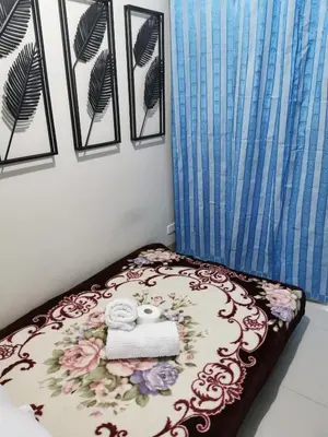a bedroom with a bed with towels on it at Mall of Asia shore 3 condotel in Manila