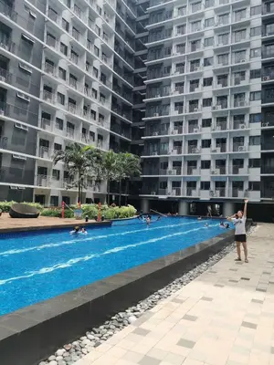 a swimming pool in the middle of a large building at Mall of Asia shore 3 condotel in Manila