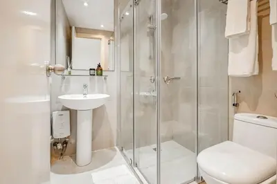 a bathroom with a shower and a toilet and a sink at Native studio hideaway in the heart of Poblacion, Makati in Manila