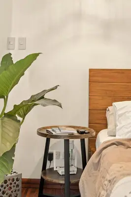 a bedroom with a table next to a bed at Native studio hideaway in the heart of Poblacion, Makati in Manila