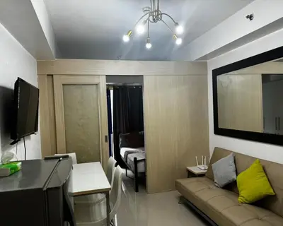 a living room with a couch and a table at Stayscape Ph in Manila