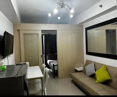 a living room with a couch and a table at Stayscape Ph in Manila