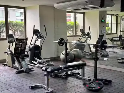 a gym with several exercise bikes in a room at Central Stay w King bed near Greenbelt 55-In TV in Manila