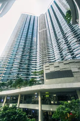 a large tall building with a lot of windows at The Zen Escape 1BR Makati swim gym park cook 300MB 5940 in Manila