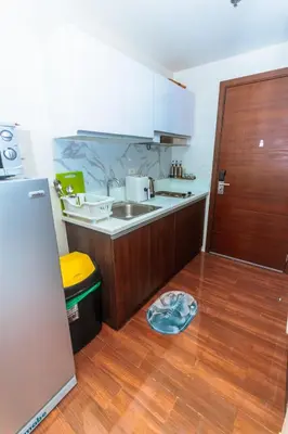 a kitchen with a sink and a wooden floor at The Zen Escape 1BR Makati swim gym park cook 300MB 5940 in Manila
