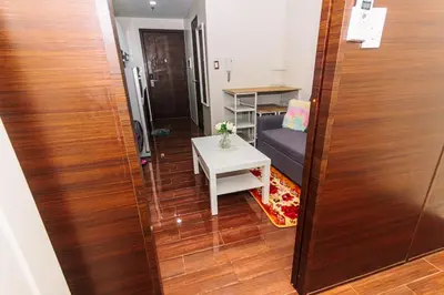 a living room with a couch and a table at The Zen Escape 1BR Makati swim gym park cook 300MB 5940 in Manila