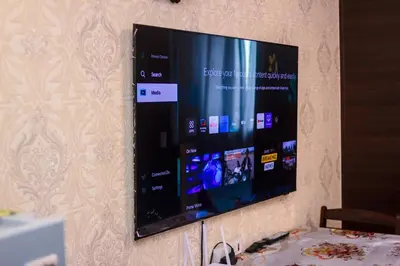 a flat screen tv hanging on a wall at The Greenbelt Groove 1BR Makati 300MB swim gym park 4034 in Manila