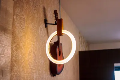 a violin hanging on a wall with a mirror at The Greenbelt Groove 1BR Makati 300MB swim gym park 4034 in Manila