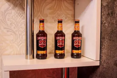 three bottles of beer sitting on a shelf at The Greenbelt Groove 1BR Makati 300MB swim gym park 4034 in Manila